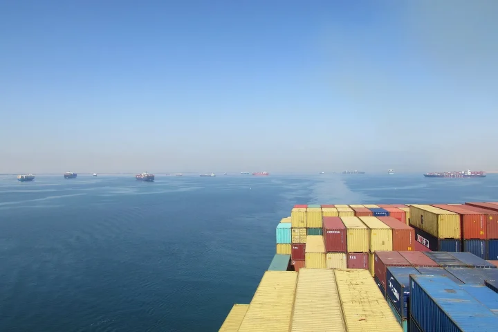 Stacked shipping containers on a cargo ship deck