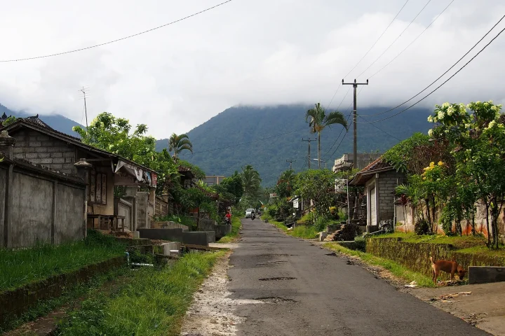 Rural road to Jatiluwih, Tabanan, Bali, with mountains behind