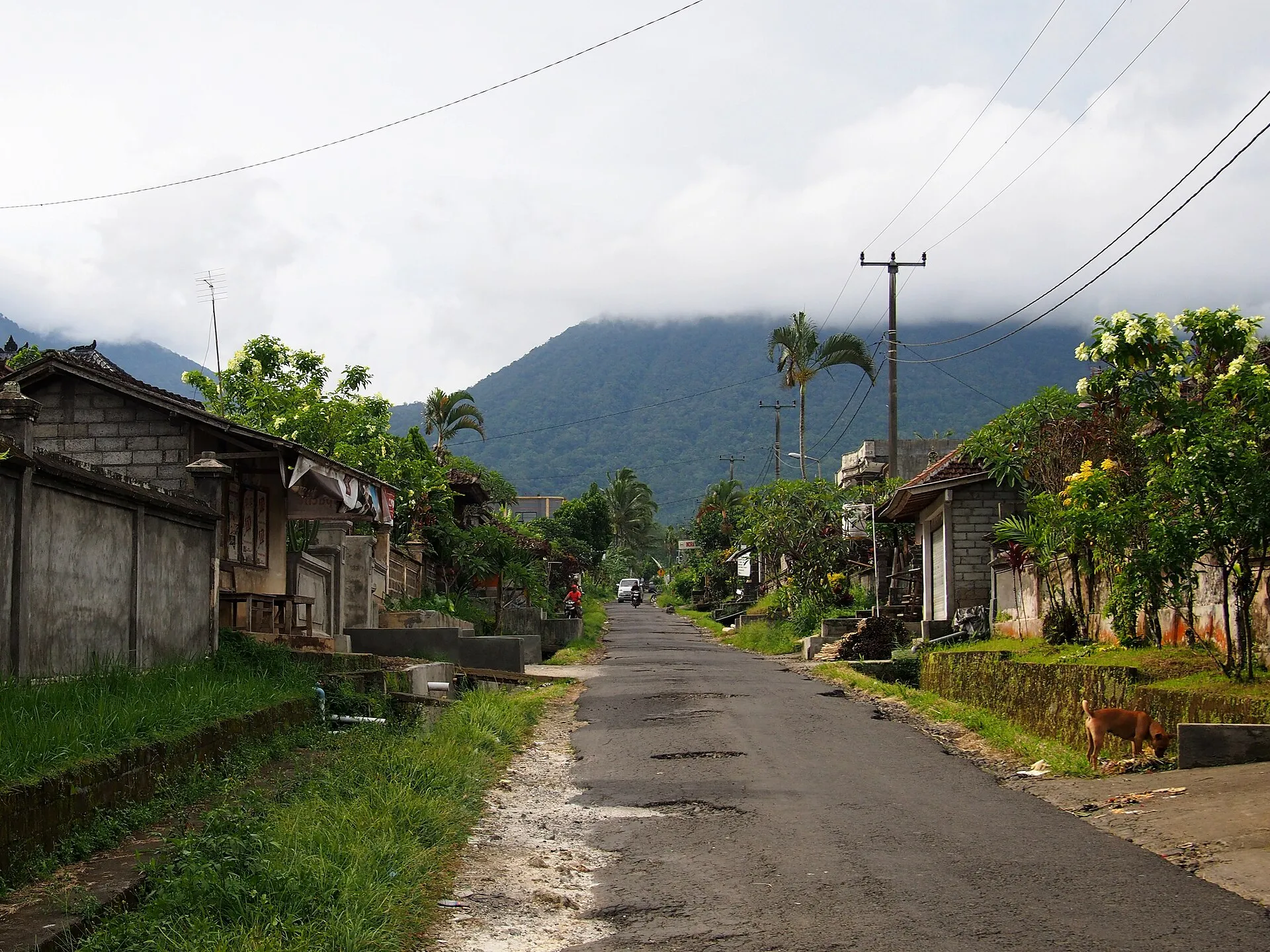 Rural road to Jatiluwih, Tabanan, Bali, with mountains behind
