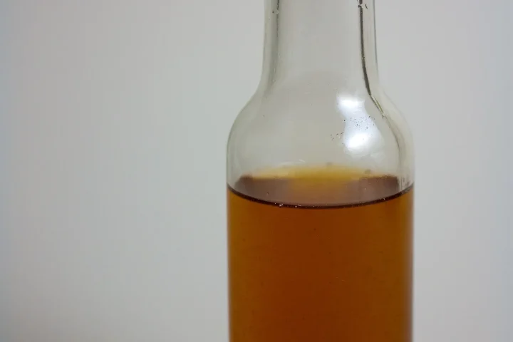Bottle of vanilla extract with vanilla beans