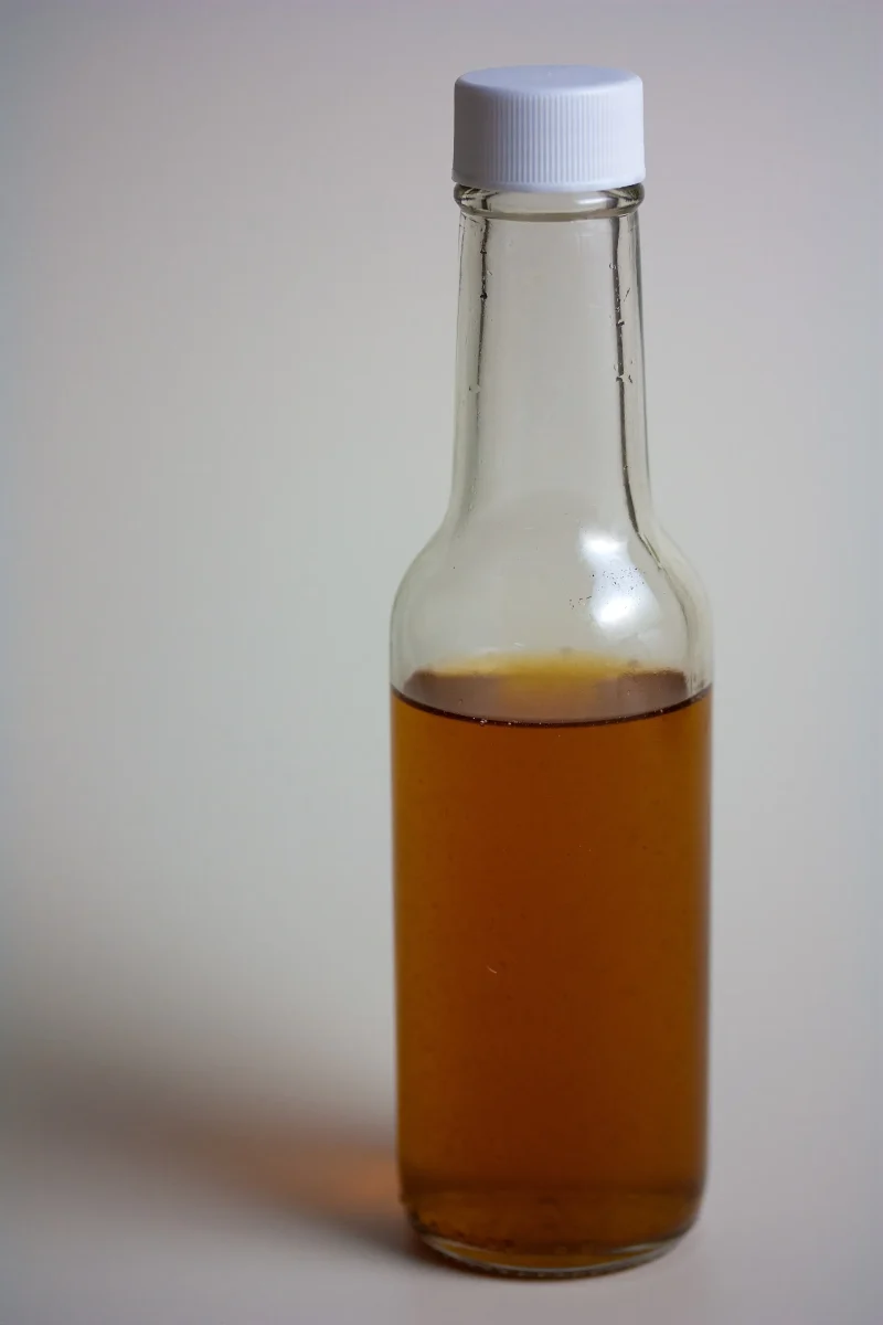 Bottle of vanilla extract with vanilla beans